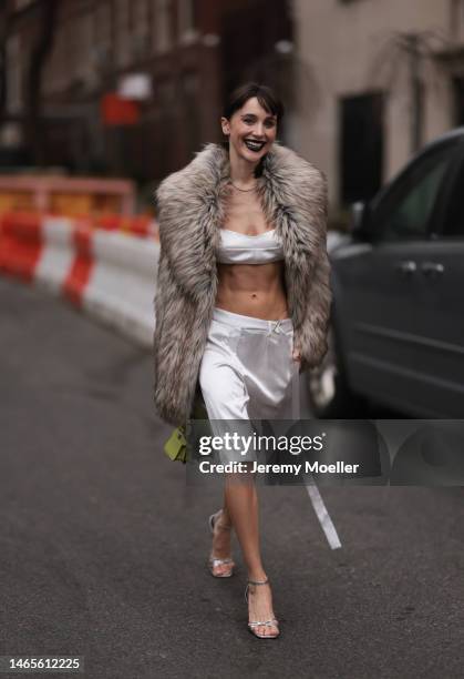 Mary Leest seen wearing diamonds earrings, diamonds necklace, white v-neck / cropped tank-top, matching white silk suit shorts, brown fake fur...