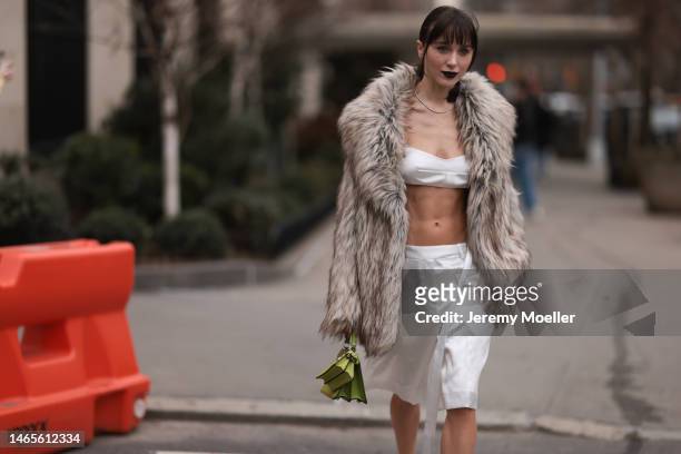 Mary Leest seen wearing diamonds earrings, diamonds necklace, white v-neck / cropped tank-top, matching white silk suit shorts, brown fake fur...