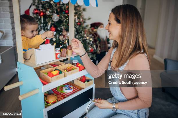 mom and son playing - christmas decorations in store stock pictures, royalty-free photos & images