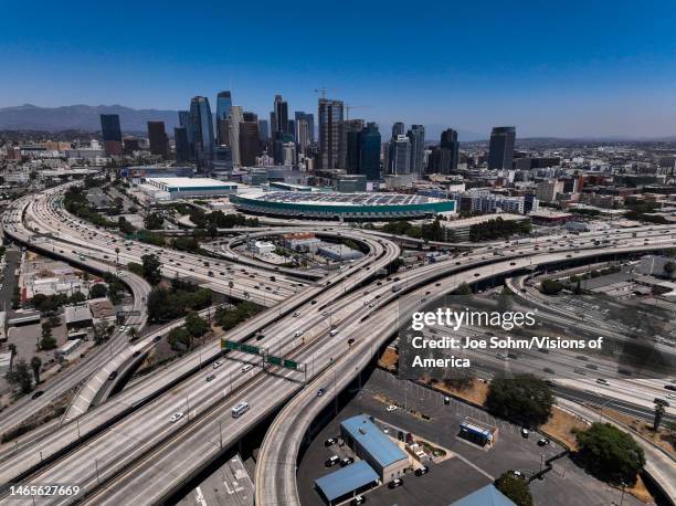 Aerial view of freeways and downtown Los Angeles with Convention Center in foreground.