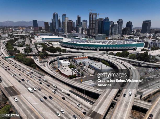 Aerial view of freeways and downtown Los Angeles with Convention Center in foreground.