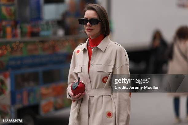 Marina Ingvarsson seen wearing Loewe black squared sunglasses, red ribbed wool turtleneck pullover, beige with embroidered red and brown circle print...