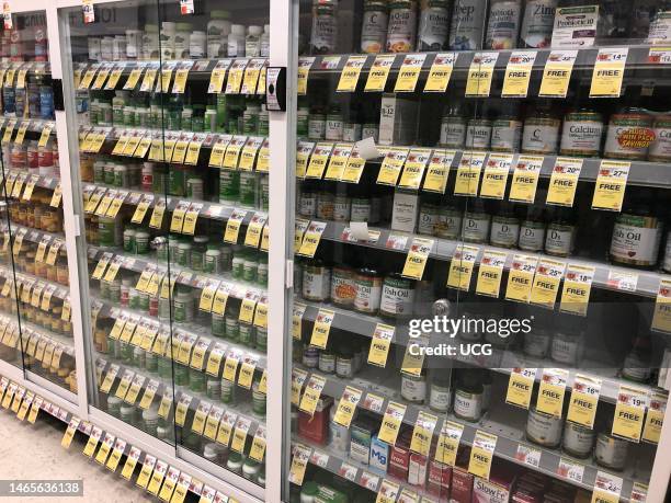 Vitamin and supplement aisle in locked cabinet to prevent theft, Walgreens Pharmacy, Queens, New York.