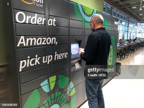 Man logging into Amazon Locker pick up at Whole Foods grocery store in Boston, Massachusetts.