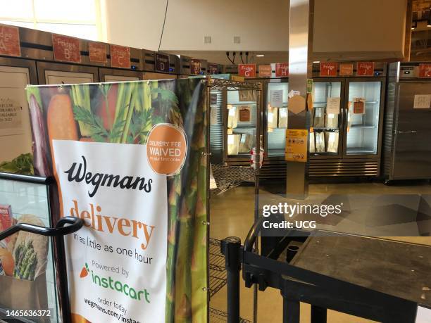 Wegmans grocery store, Instacart Pick up area with shelves and refrigerators, Boston, Massachusetts.