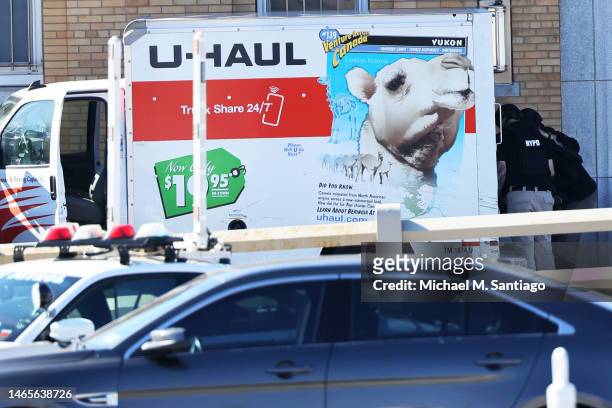 Officers search a crashed U-Haul truck on Hamilton Avenue on February 13, 2023 in the Red Hook neighborhood of the Brooklyn borough in New York City....