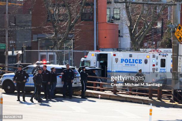 Officers stand guard as a search of crashed U-Haul truck is conducted on Hamilton Avenue on February 13, 2023 in the Red Hook neighborhood of the...