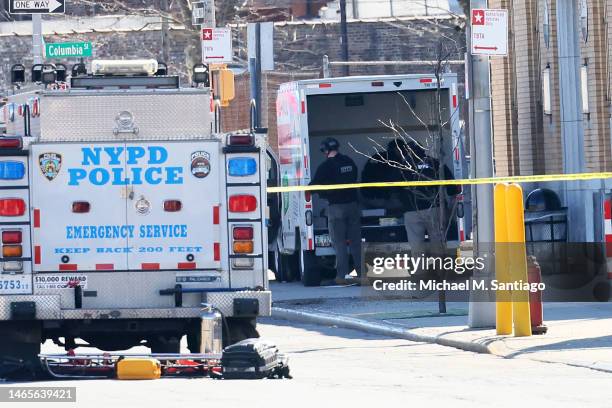 Officers search a crashed U-Haul truck on Hamilton Avenue on February 13, 2023 in the Red Hook neighborhood of the Brooklyn borough in New York City....