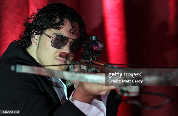 Mad Max Newton performs his crossbow act as part of Gerry Cottle's Circus: 50 Acts In 100 Minutes, on June 19, 2012 in Shepton Mallet, England. To...