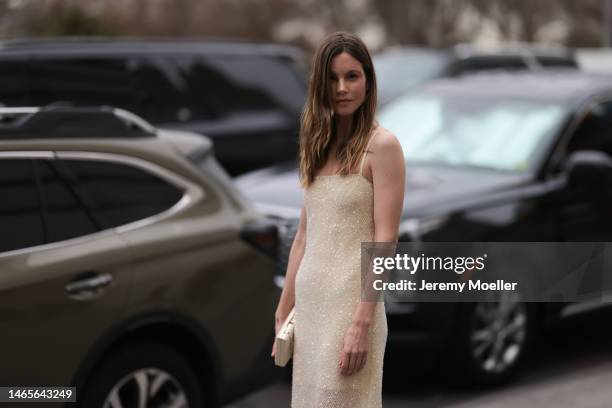 Sylvia Hoeks seen wearing a pale yellow embroidered sequined long tube dress, white latte shiny leather crocodile print pattern clutch, outside Jason...