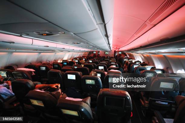 airplane interior during flight - vliegtuigstoel stockfoto's en -beelden