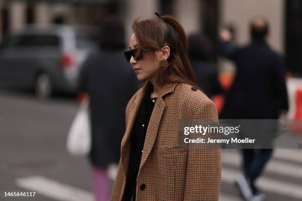 Guest wears Celine black square sunglasses, Miu Miu gold earrings, black tweed with gold buttoned jacket, yellow with brown / black houndstooth print...