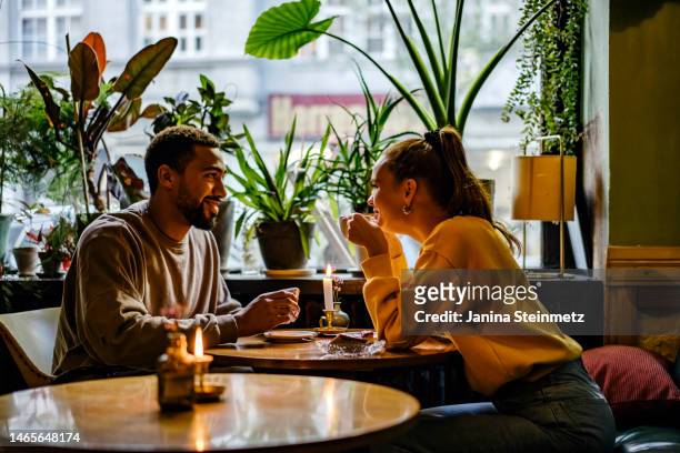 couple on a weekend date at cute cafe - first date stockfoto's en -beelden