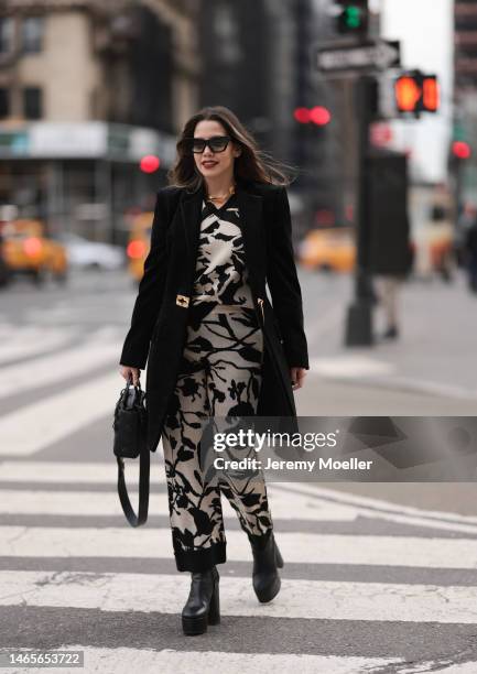 Lenia Perez wearing black shades, black / white patterned Vipop Set, gold VIPOP Necklace, gold Brazalete VIPOP, black small Dior bag, black velvet...