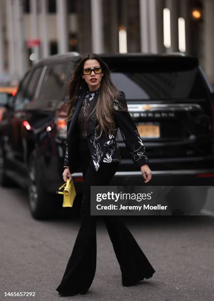 Lenia Perez wearing black / white patterned Vipop Blazer and top, black Stouls pants, gold VIPOP Brazalete, black / yellow VIPOP glasses, gold VIPOP...