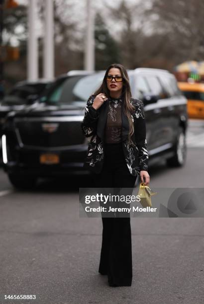 Lenia Perez wearing black / white patterned Vipop Blazer and top, black Stouls pants, gold VIPOP Brazalete, black / yellow VIPOP glasses, gold VIPOP...