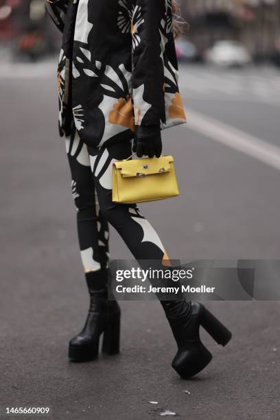 Lenia Perez wearing colorful VIPOP Set, black Yves Saint Laurent Plateauboots and a small yellow Hermès bag during the New York Fashion Week on...