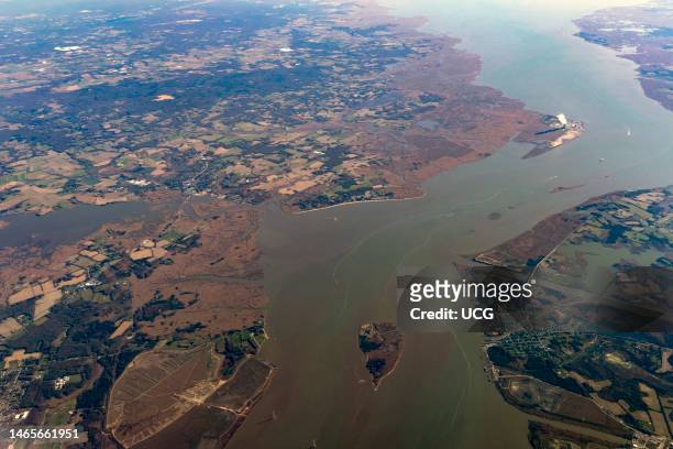 Delaware River estuary, New Jersey and Delaware . Steam rises from a cooling tower at the Salem nuclear power plant in the background on the New...
