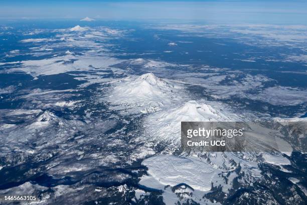 Aerial view northward of the central and northern Oregon Cascade Volcanoes, from South Sister in the right foreground to Mt. Jefferson to Mt. Hood....