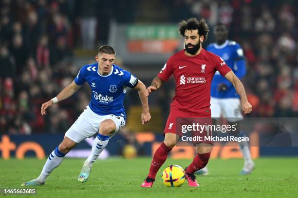 Mohamed Salah of Liverpool is challenged by Vitaliy Mykolenko of Everton during the Premier League match between Liverpool FC and Everton FC at...