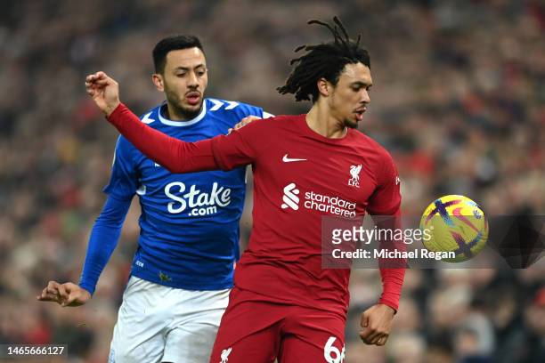 Trent Alexander-Arnold of Liverpool is challenged by Dwight McNeil of Everton during the Premier League match between Liverpool FC and Everton FC at...
