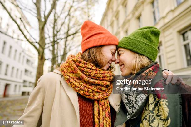 female couple nose to nose smiling - falling in love stock pictures, royalty-free photos & images