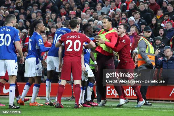 Andrew Robertson and Virgil van Dijk of Liverpool FC clash with players of Everton FC during the Premier League match between Liverpool FC and...