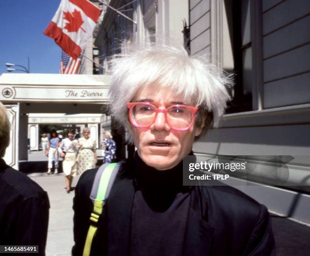 American visual artist, film director, and producer Andy Warhol poses for a portrait outside of The Pierre Hotel in New York, New York, August 12,...