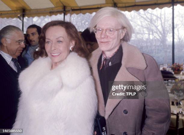 American actress Paulette Goddard and American visual artist, film director, and producer Andy Warhol pose for a portrait before an event in New...