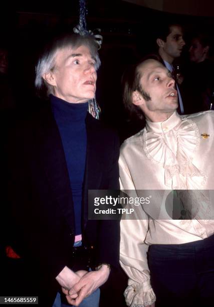 American visual artist, film director, and producer Andy Warhol and actor Rock Brynner at the Hard Rock Cafe in New York, New York, March 1984.