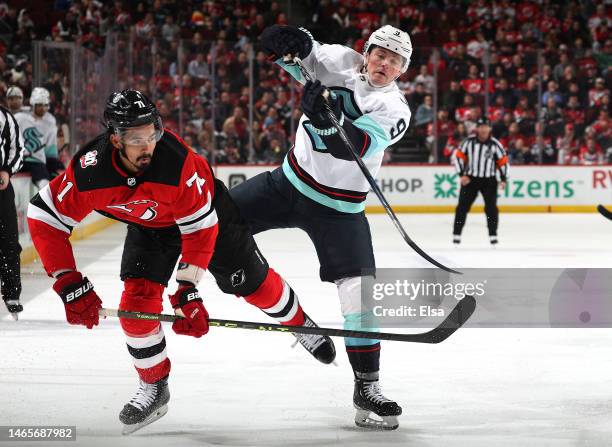 Jonas Siegenthaler of the New Jersey Devils and Ryan Donato of the Seattle Kraken collide during the third period at Prudential Center on February...