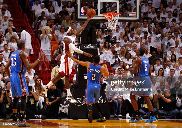 LeBron James of the Miami Heat drives for a shot attempt in the second half against Thabo Sefolosha of the Oklahoma City Thunder in Game Four of the...