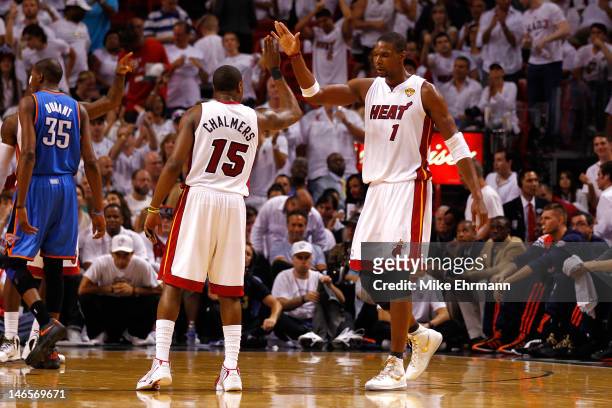 Chris Bosh and Mario Chalmers of the Miami Heat celebrate a play in the second half against the Oklahoma City Thunder in Game Four of the 2012 NBA...