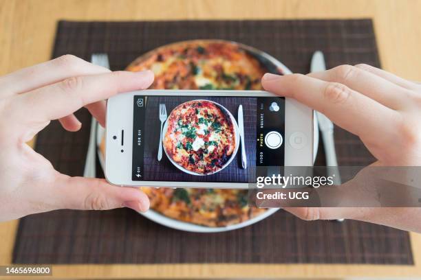 Taking a food photo of pizza with Apple iPhone camera.