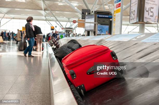 Suitcase on the luggage carousel at Stansted Airport, London, UK.