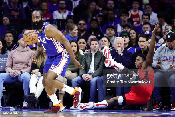 James Harden of the Philadelphia 76ers and Jae'Sean Tate of the Houston Rockets challenge for a loose ball during the first quarter at Wells Fargo...