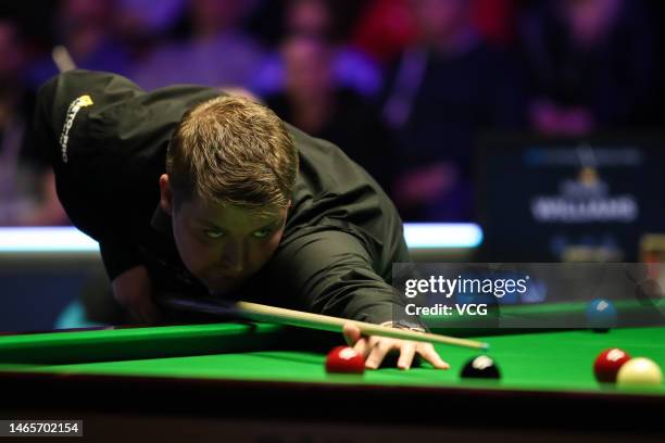 Michael White of Wales plays a shot in the qualifying match against Mark J. Williams of Wales on day one of 2023 Betvictor Welsh Open at Venue Cymru...