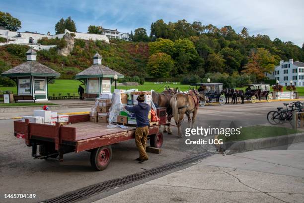 Mackinac Island, Michigan, Only horses and bicycles allowed on the island. Horse and wagon delivering goods to local businesses.