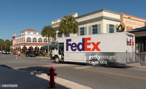 The Villages, Florida, International packet and parcel carrier delivery truck making a stop in a Florida town center.