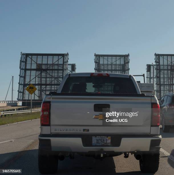 Port Canaveral, Florida, Three drawbridges raised to allow shipping pass, when lowered vehicles can pass over the causeway.