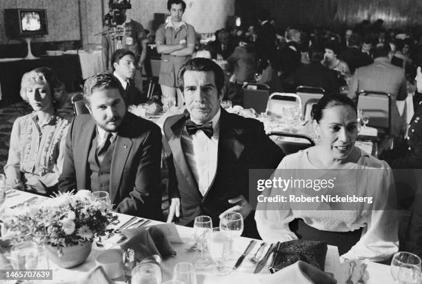 With unidentified others, married couple General Efrain Rios Montt & Maria Teresa Sosa Avila sit at a table during a formal dinner, Guatemala City,...