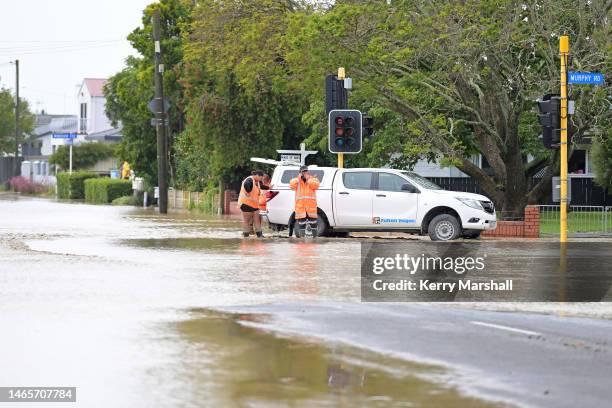 Contractors close flooded streets in Taradale on February 14, 2023 in Napier, New Zealand. New Zealand has declared a national state of emergency...
