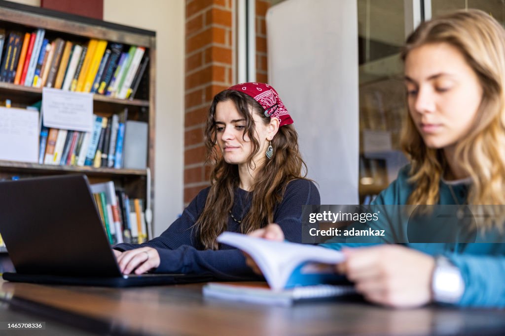 Working In College Female College Students Working On A Laptop At College High-Res Stock ...