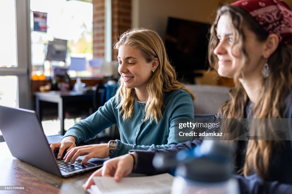 Working In College Female College Students Working On A Laptop At College High-Res Stock ...