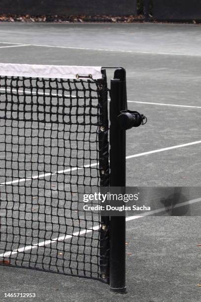 net pole on a tennis court - tennis ball on court stock pictures, royalty-free photos & images