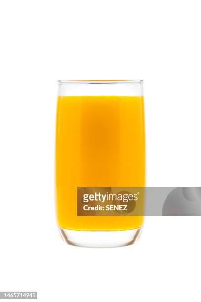 orange juice in glass against white background - orange juice stock-fotos und bilder