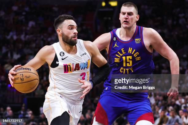 Max Strus of the Miami Heat drives against Nikola Jokic of the Denver Nuggets during the fourth quarter of the game at Miami-Dade Arena on February...