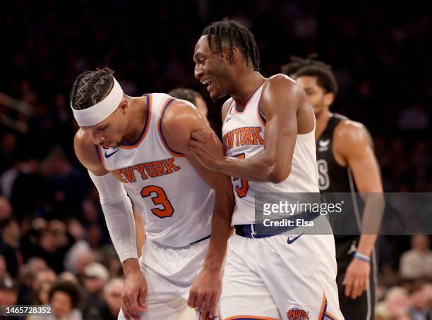 Josh Hart of the New York Knicks is congratulated by teammate Immanuel Quickley after Hart drew the foul during the second half against the Brooklyn...