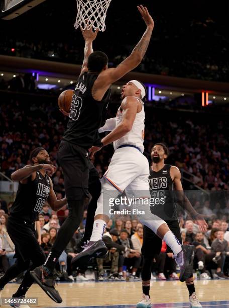 Josh Hart of the New York Knicks heads for the net as Nic Claxton of the Brooklyn Nets defends during the second half at Madison Square Garden on...