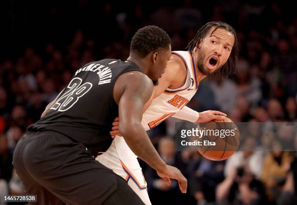 Jalen Brunson of the New York Knicks directs his teammates as Dorian Finney-Smith of the Brooklyn Nets defends during the second half at Madison...